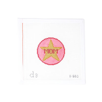 Hand-painted needlepoint canvas by Doolittle Stitchery on 18 mesh, featuring a 3" pink round with a star in the center and the word “Mom.” Perfect for Mother’s Day, this sweet design can be stitched with metallic thread for added sparkle and finished as a special ornament, gift tag, or mini framed piece to celebrate mom.