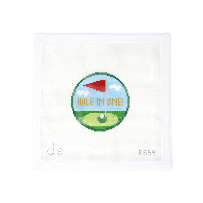 Hand-painted needlepoint canvas on 18 mesh featuring a celebratory “Hole in One” round with a golf flag and ball in the hole. Designed with the option to stitch the details in metallic fiber for extra flair, this sporty design is perfect for finishing as an ornament, gift tag, or keepsake to commemorate a special golf achievement.