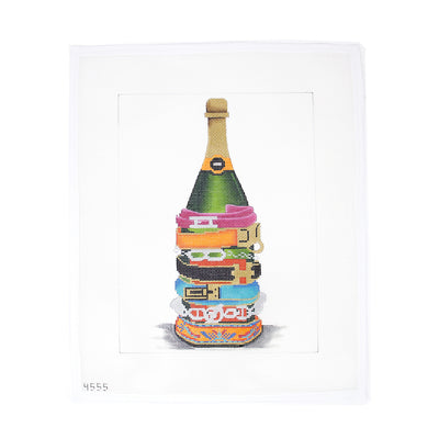 Champagne Bottle needlepoint canvas designed by Alice Peterson, featuring a bottle adorned with colorful designer bracelets. Printed on 13-count mesh, perfect for creating framed art, pillows, or a chic holiday ornament. Add beads or metallic threads for extra shine and detail. Mesh size: 13-count.