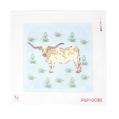 Bold 12x12 needlepoint canvas featuring a majestic longhorn centered on a vivid blue background, framed by an array of colorful flowers. A perfect blend of western charm and feminine flair. Ideal for finishing as a standout pillow or statement wall hanging