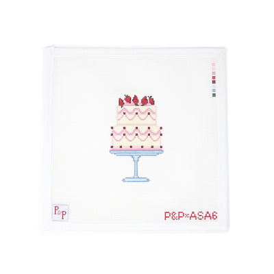 Delightful needlepoint canvas by Penny & Penny featuring a two-tiered pink cake with strawberry toppings and decorative icing details, displayed on a pale blue cake stand. A charming design perfect for birthdays or celebrations—ideal for finishing as a door hanger, pillow, or framed accent. Mesh size: 18-count, square canvas.