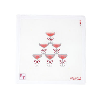 Chic needlepoint canvas by Penny & Penny featuring a stacked tower of cosmopolitan cocktails, each glass tied with a mini red bow. The stylish and festive design makes a fun statement piece—perfect for finishing as a tray insert, bar cart decor, or framed for a home bar. Mesh size: 18-count, square canvas."