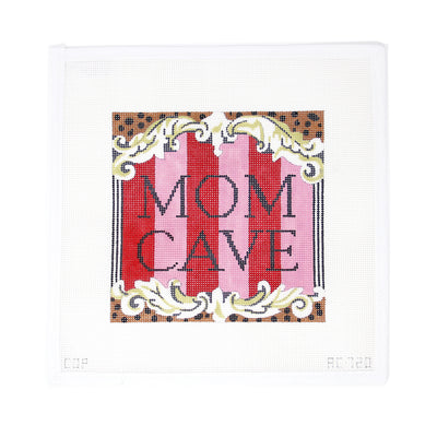Large needlepoint canvas by Colors of Praise featuring the phrase 'Mom Cave' in bold lettering, set against a pink and black background with leopard print accents. A fun and stylish design ideal for finishing as a statement pillow, door hanger, or framed wall art. Printed on 13-count mesh. Mesh size: 13-count, rectangular