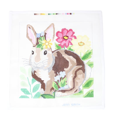 Garden Bunny needlepoint canvas with floral accents in pink, yellow, and blue. Printed on 18-count mesh, perfect for creating framed art, pillows, or ornaments. Add beads or embroidery for extra detail. Mesh size: 18-count, designed by Jean Smith.