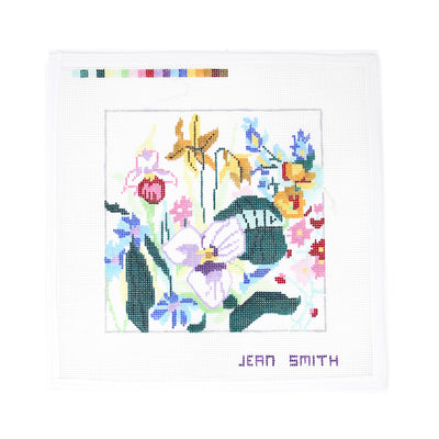 Hand-painted needlepoint canvas featuring an array of wildflowers in various colors and shapes—perfect for finishing as a floral pillow, elegant framed piece, or a charming springtime tray.