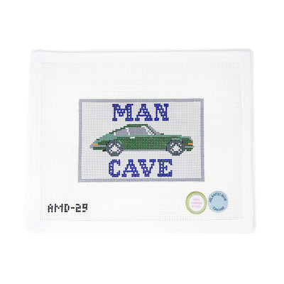 Hand-painted needlepoint canvas featuring a “Man Cave” sign with a sleek green Porsche, perfect for Father’s Day or masculine décor. Painted on 13 mesh, this bold design is ideal for finishing as a sign for an office, garage, or study, or as a standout pillow for a car enthusiast’s space.