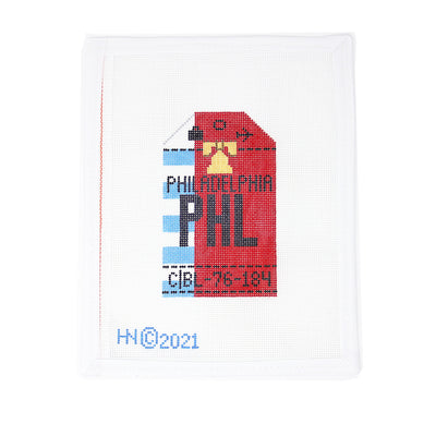 Hand-painted 18 mesh needlepoint canvas of a Philadelphia luggage tag featuring the Liberty Bell in a patriotic red, white, and blue retro design. Individually produced in the USA in small batches by a woman-owned boutique with over 30 years of experience. Specially curated for Hedgehog Needlepoint, perfect for finishing as a travel tag or personalized accessory