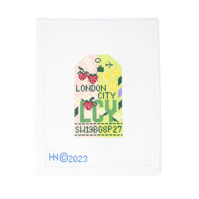 Hand-painted 18 mesh needlepoint canvas of a London City luggage tag featuring tennis balls, strawberries, and floral accents. A playful nod to Wimbledon tradition, this green and pink retro design is produced in the USA in small batches by a woman-owned boutique with over 30 years of experience. Specially curated for Hedgehog Needlepoint and perfect for finishing as a sporty travel tag or summer accessory.