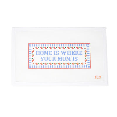 Hand-painted needlepoint canvas on 18 mesh featuring the phrase "Home is where your mom is" in soft blue script. The design is framed with a delicate floral and linear border, making it a heartfelt option for Mother’s Day stitching. Ideal for finishing as a framed piece, small pillow, or door hanger.