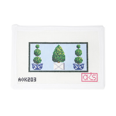 Hand-painted needlepoint canvas by Ann Kaye Studio featuring three charming topiaries in pots on a baby blue background, designed on 13 mesh. Perfect for beginners, this fresh and classic design is ideal for finishing as a clutch insert, zip pouch, or framed piece for a garden-inspired accent.