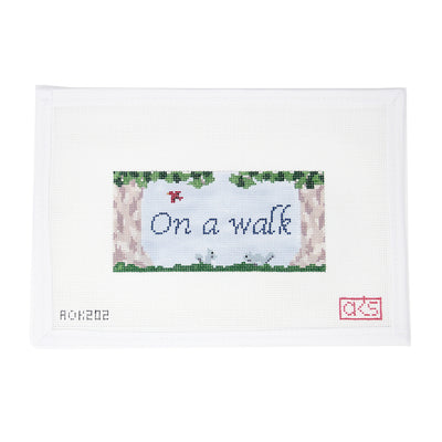 Hand-painted needlepoint canvas on 18 mesh featuring the phrase “On a Walk” in graceful cursive, framed by trees, birds, and playful squirrels. A charming, nature-themed design perfect for finishing as a peaceful sign, framed décor, or a woodland-inspired pillow.
