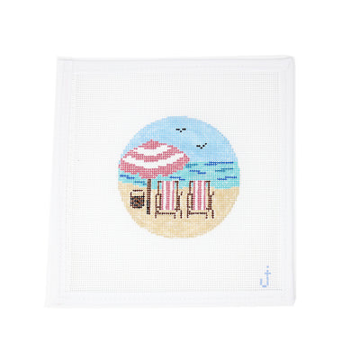 Hand-painted needlepoint canvas on 13 mesh in an ornament round featuring a beach scene with pink striped chairs – Perfect for holiday or coastal-themed stitching projects