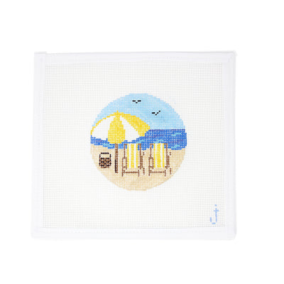 Hand-painted needlepoint canvas on 13 mesh in an ornament round featuring a beach scene with yellow striped chairs – Perfect for holiday or coastal-themed stitching projects