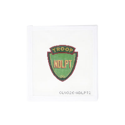 Vintage-style needlepoint canvas featuring an old-school troop shield design with the bold letters 'NDLPT' at the center—perfect for the needlepoint community. A playful and nostalgic piece ideal for finishing as a patch, sign, ornament, or small tray. Printed on 18-count mesh.