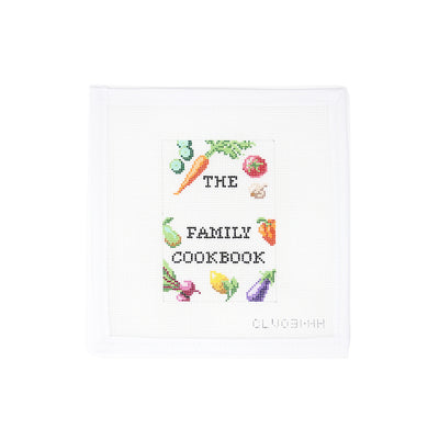 Customizable needlepoint canvas designed as the cover of a family cookbook, featuring a charming arrangement of fruits and vegetables including tomatoes, carrots, grapes, and more. A blank banner across the top allows for adding a family name or personalized title. Perfect for finishing as a cookbook cover, kitchen sign, or framed kitchen art. Printed on 18-count mesh.