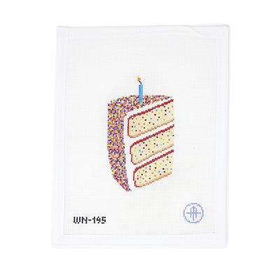 Needlepoint canvas featuring a slice of birthday cake with pastel frosting, rainbow sprinkles, and a blue candle. "It’s Sprinkles Cake" by Wheelhaus Needlepoint, hand-painted on 18 mesh canvas by Colonial Needlepoint.
